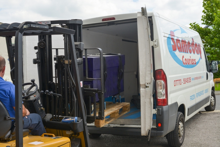 Image of a pallet being loaded into a courier vehicle